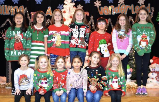 Wellington Elementary School students and staff don their festive and fun, ugly and bright Christmas sweaters for a creative activity prior to the release of school Thursday, Dec. 21. Courtesy Photos