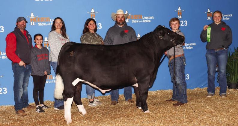 Wellington Elementary School fifth-grader Kane Waters exhibits his sixth-place lightweight Maine-Anjou steer at the recent 2023 Houston Livestock Show and Rodeo, which took place during Spring Break. From left, Wellington FFA Advisor Drew Taylor, Kynzlea Taylor, Chandi Taylor, Landey Waters, B.J. Waters, Kane Waters, Briley Waters. Courtesy Photo