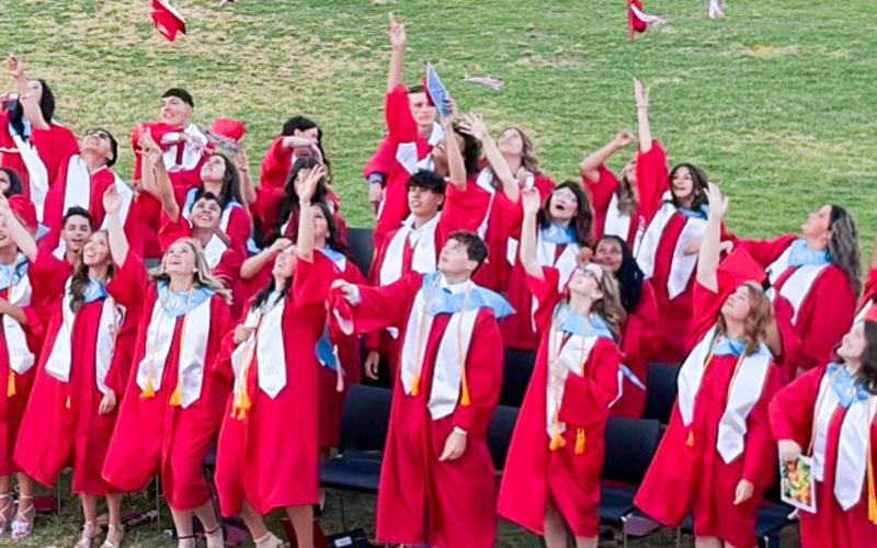 Marking the end of their high school journey, the Wellington Skyrocket Class of 2026 graduates toss their caps in celebration of receiving their diplomas following the 7 p.m. ceremony Friday, May 8 at Powell Field. BEV ODOM/THE GREENBELT INTREPID
