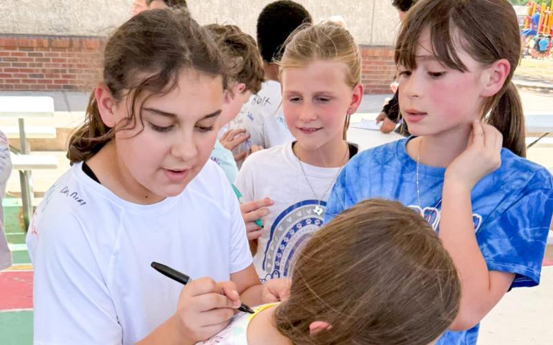 Donned in white T-shirts, Childress Elementary School fourth-grade students become walking yearbooks, letting fellow students sign their names on their backs. CHILDRESS ELEMENTARY SCHOOL