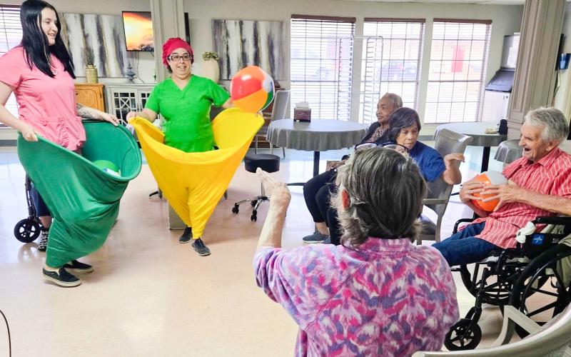 Situated in the dining room and attired in “Granny Pants,” Wellington Care Center staff encourage residents to toss balls into oversized, wearable pants. Fun and laughter filled the room, and everyone had a great time working together, staying active and sharing plenty of smiles. Wellington Care Center