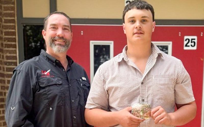Wellington High School (WHS) Future Farmers of America (FFA) Advisor Drew Taylor congratulates sophomore Aison Skelton on his first-place accolade in the recent SMAW 1F Wichita Falls Welding Contest. WELLINGTON HIGH SCHOOL