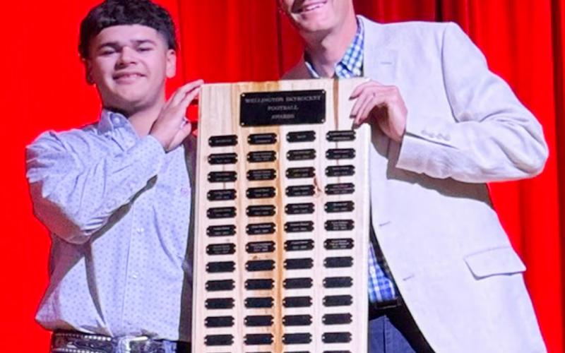 Wellington High School senior KJ Molina receives the Football Larry Wright Memorial Award, presented by Athletic Director Greg Proffitt.