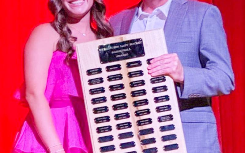 Wellington High School junior Ceighley Killian accepts the Girls’ Basketball Fighting Heart Award, presented by Coach Shannon Fisher.