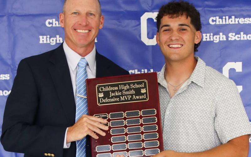 Colton Teichelman receives the Jackie Smith Defensive Most Valuable Player Award, presented by Defensive Coordinator Lee Brandon.