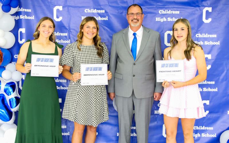 Landry Hunter receives the Lady Cat Basketball Offensive Most Valuable Player (MVP) Award, Emma Jalomo receives the Lady Cat Basketball Defensive MVP Award and Kinley Galligan receives the Fighting Heart Award, presented by Lady Cat Head Basketball Coach Eric Davis. From left: Hunter, Jalomo, Davis, Galligan.