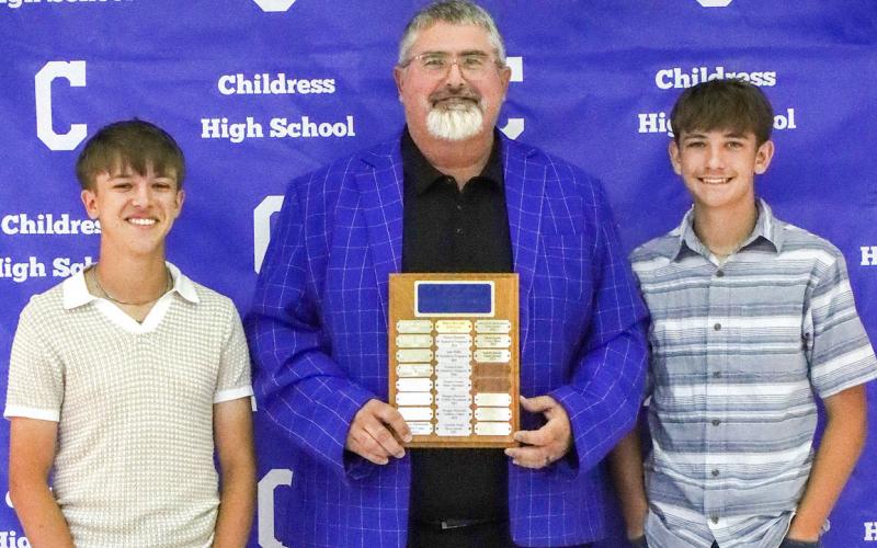 Ashton Preston, left, and Jered Preston, right, receive the Bobcat Golf Co-Most Valuable Player Award, presented by Coach Trenton Boyd.