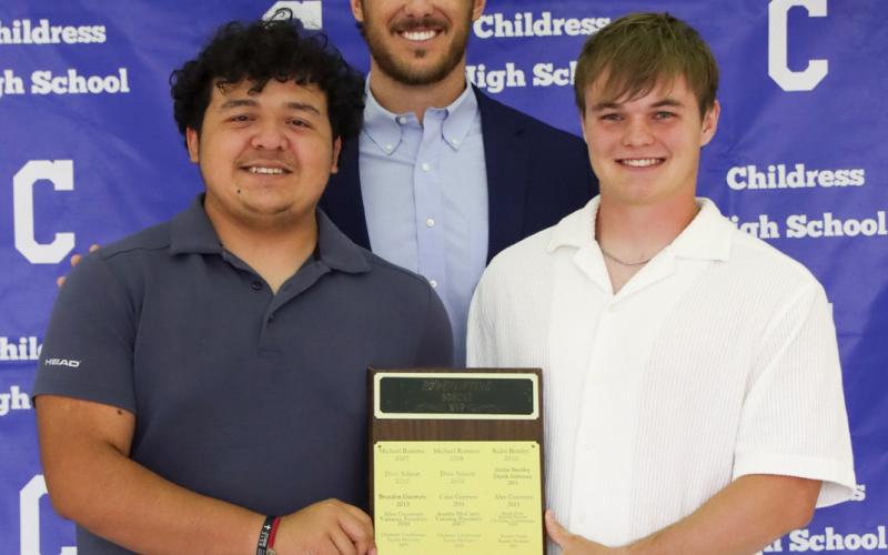 Marcus Mendez, left, and Ben Oldham, right, receive the Bobcat Powerlifting Most Valuable Player Award, presented by Coach Reid Ware.