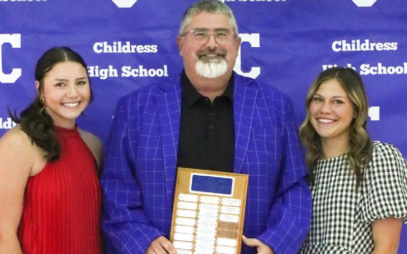 Colee Cox, left, and Emma Jalomo, right, receive the Lady Cat Golf Co-Most Valuable Player Award, presented by Coach Trenton Boyd.