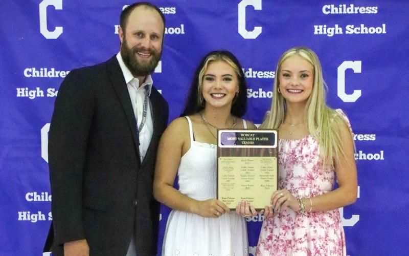 Channing Burnett, right, and Tandi Thomas, center, are awarded the Lady Cat Doubles Most Valuable Player Award, presented by Athletic Director Bo Helm.