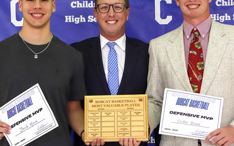 Jacob Mora and Cutter Bruce receive the Bobcat Basketball Defensive Most Valuable Player Award, presented by Bobcat Head Basketball Coach Colby Schneiderjan.