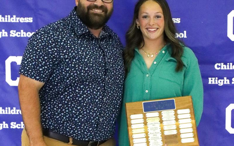 Bethani Spencer receives the Lady Cat Track Most Valuable Player Award, presented by Coach Kolby Pool.