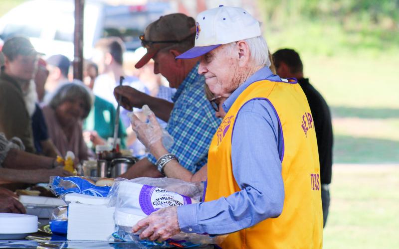 Memphis Lions Club members serve hamburgers at the 69th Annual Park Opener Friday, May 9 at Memphis City Park. ELIZABETH TANNER/THE GREENBELT INTREPID