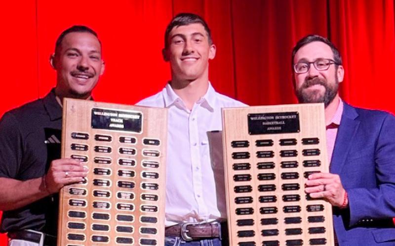 Wellington High School Junior Callen Kane accepts the Boys’ Track Sprinter Award, presented by Coach Jared Casas, and the Boys’ Basketball Offensive Award, presented by Coach Colton Holmes.