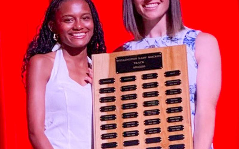 Wellington High School Senior Angela Lewis accepts the Girls’ Track Most Valuable Player Award, presented by Coach Courtney Head.