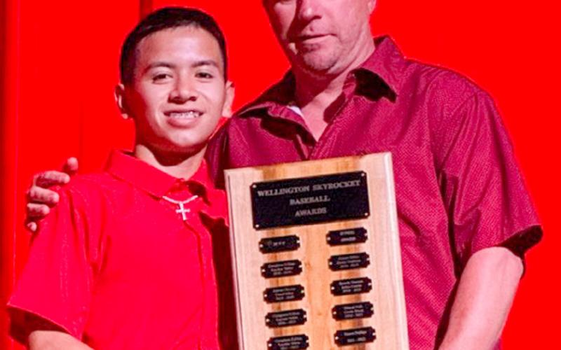 Wellington High School Junior Dahmian Salinas accepts the Baseball Most Valuable Player Award, presented by Coach Jeff Anderson.