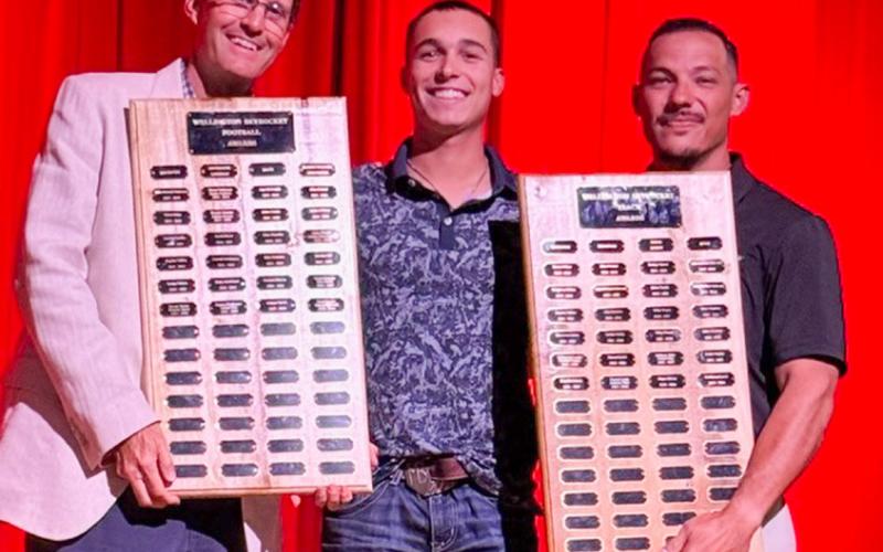 Wellington High School Senior Major Brown garners the Football Outstanding Receiver Award, presented by Athletic Director Coach Greg Proffitt, and the Boys’ Track Field Event Award, presented by Coach Jared Casas. SHAUNA SALINAS/THE GREENBELT INTREPID