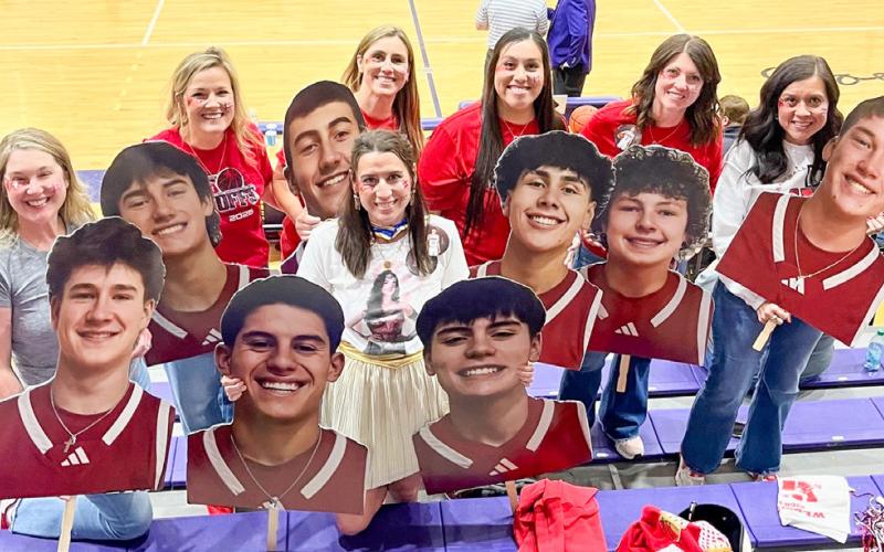 With a “superhero” theme, Skyrocket moms display cutouts of basketball players prior to the UIL 2A Division 1 Regional Final Championship Friday evening, March 6 at Canyon High School. From left: Amanda Kane, Amy Inman, Christy Kane, Ashly Cantu, Denise Garcia, Megan Wischkaemper, Sandy Killian. Courtesy Photo