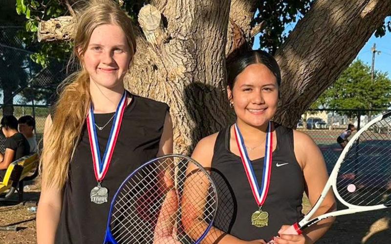 Memphis’ Alexa Rodriguez, right, takes first place in the girls’ singles Monday, May 11 at the Memphis Tennis Tournament. Hedley’s Abby Hood, left, took silver. MEMPHIS ISD