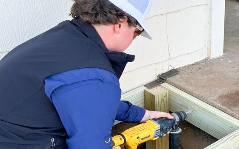 A Rocket Leo Club recruit, Wellington High School junior Hunter Hedrick volunteers his time on Saturday, Feb. 7, assisting with building ramps in Wellington.