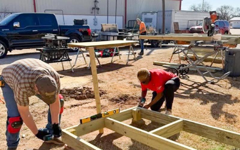 Members of Wellington Lions Club and Amarillo volunteers build ramp frames in the staging area during the Saturday, Feb. 7 construction project.