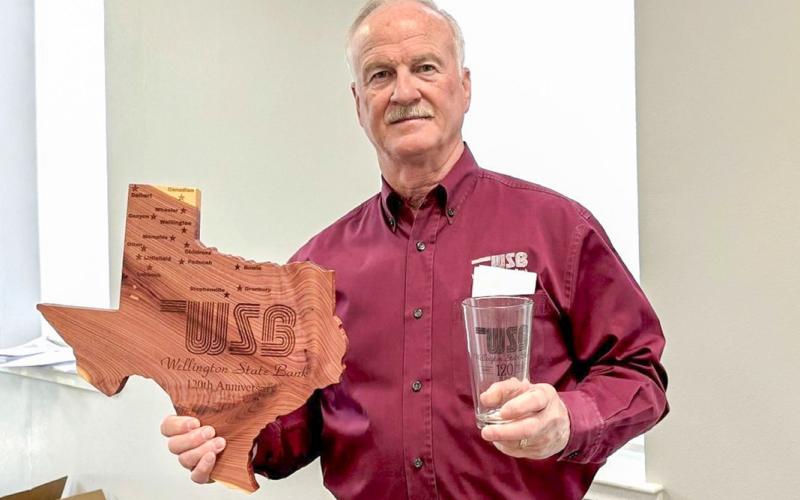 Wellington State Bank President and Chief Executive Officer (CEO) Richard Sims displays commemorative gifts given to stockholders in celebration of the bank’s 120th anniversary, including Texas-shaped cedar plaques engraved with each Wellington State Bank location and drinking glasses, each featuring the 120th anniversary mark. WELLINGTON STATE BANK