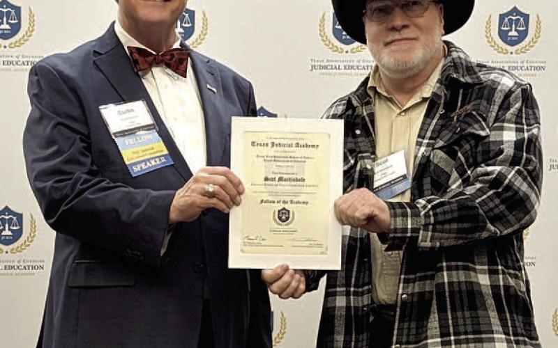 Lubbock County Judge Curtis Parrish, representing the Texas Association of Counties, presents Collingsworth County Judge Scot Martindale his Fellow of the Academy certificate. Texas Association of Counties