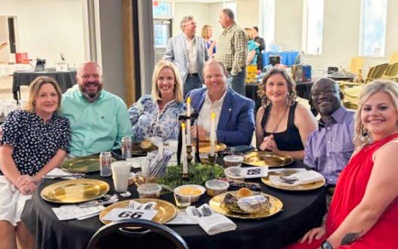 Court Appointed Special Advocates (CASA) of the Rolling Plains supporters, including Josh and Candice Talley, Meme Bass, Jack Owens, Joanna and Roman Buckner and Jill Lindsey, all of Memphis, partake in the Saturday, May 2 Gala festivities at the Wellington Community Center. Visitors in the background shop the diverse selection of silent auction items. COURTESY PHOTO