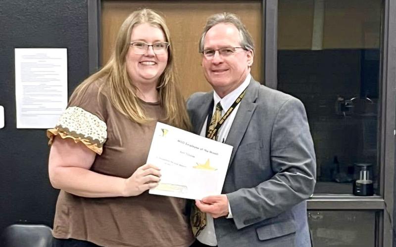 Memphis Independent School District (ISD) Superintendent William Alexander congratulates March Employee of the Month Ami Tribble, who teaches first and second-grade mathematics at Austin Elementary School. Memphis ISD