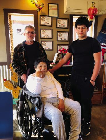 Jerry, Mona and Elijah Granados gather in the dining room of Mona’s Firehouse Cocina for one last time Friday afternoon, Dec. 20 on 8th St. in Wellington. The decline in her health caused the family to make the difficult decision to close the restaurant. The Red River Sun/Bev Odom