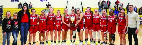 The Wellington Lady Rockets accept the bi-district championship trophy Monday, Feb. 13 at River Road High School in Amarillo. From left: Kaesyn Kane, Ava Kate Inman, Coach Skyler Warrick, Brynlee Proffitt, Leslie Orozco, Briley Waters, Brynlee Phillips, Kaitlin Bawcom, Charley Wilbur, Audrey Jones, Kali Brewer, Presley Kane, Harlee Gomez, Asia Shrubs, Abby Garcia, Coach Cade Brown. Lukas Wilbur Photography