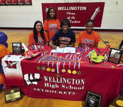 Wellington High School senior DeMarcus Lewis signs a National Letter of Intent to run track at Langston University, located in Oklahoma. From left: his mom, Angela Lewis; sister Aleah Lewis; Lewis; sister Angela Lewis. Wellington High School