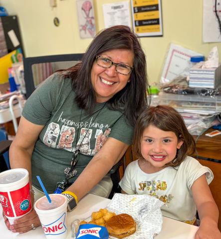 Austin Elementary School first-grade student Astrid Benetiz cashes in her Classroom Hero points to have lunch with her teacher, Norma Ross. MEMPHIS ISD