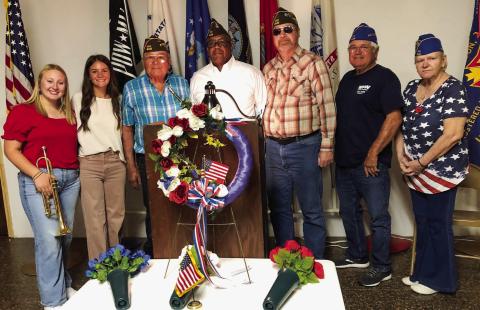 Glynn Moore Veterans of Foreign Wars (VFW) Post 6439 hosts the 2025 Collingsworth County Memorial Day Service at 11 a.m. Monday, May 26 at the Post Hall. Program participants gather amongst the Remembrance Ceremony wreath and flowers following the service. From left: Trumpeter Allie Duncan, Vocalist Heather Peters, Quartermaster Epifanio “Jr.” Castillo, Commander Rodney Bishop, Chaplain Jeff Pastor, Auxiliary President John O’Rear, Auxiliary Trustee Jane Campbell. The Red River Sun/Bev Odom