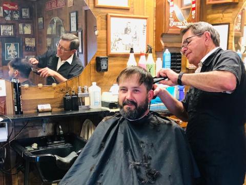 Clarence Duke recalls his first haircuts as a kid from Jim Ellis at Dick Judd’s Barber Shop, where Jim began his career in 1987. Duke slipped in for a final haircut on Jim’s last day of business, Friday, Dec. 29. The Red River Sun/Bev Odom