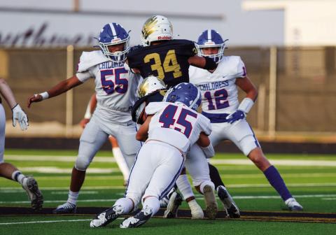 Childress’ Reid Felton (45), Isaac Salinas (55) and Seth Taylor (12) work to take down Bushland’s Stockton Blount (5) and Breckan Reed (34) during the 43-0 matchup Friday Sept. 9 at Falcon Stadium. The Red River Sun/Nicole Dill