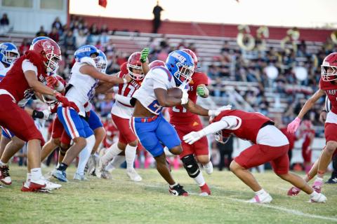 Childress running back Lucian Davis stiff arms a Friona defender during the Bobcats’ 52-0 district opening shutout Friday, Oct. 10 at Chieftain Stadium in Friona. 