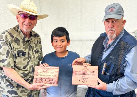 Wellington Junior High School sixth-grader Andrew Skelton, center, accepts the championship award for Wellington Gun Club’s Junior Trap and Junior Skeet competitions at the Saturday, Oct. 18 event. Gun Club Board of Directors Cliff Waller, left, and Kent Riley congratulate Skelton.  
