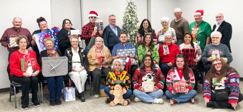 Members of Wellington Lions Club and guests unwind with a Chinese gift exchange during the Monday evening, Dec. 15 Christmas party in the Club Room of the Bura Handley Community Center. 