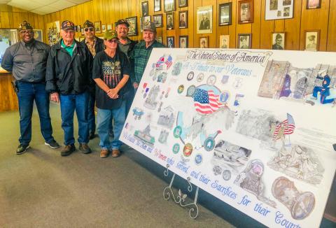Alesia “Lisa” Freeland, a veteran of the U.S. Army, displays her four-foot-by-eight-foot mural designed to honor all the branches of the military, in all conflicts, from the Revolution to the Space Age. Freeland displayed her artwork at the recent Veterans Day lunch at the Glynn Moore Veterans of Foreign Wars Post 6439, the new home of “A Veteran’s Tribute.”