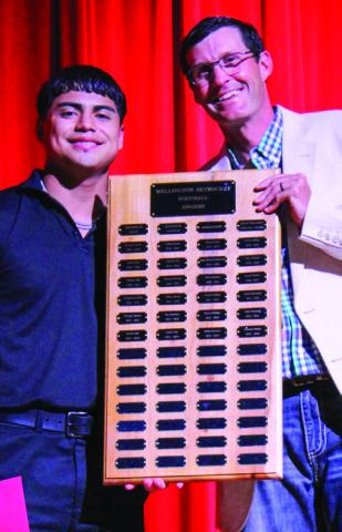 Wellington High School (WHS) senior Miguel Rincon accepts the Football Defensive Linebacker Award, presented by Athletic Director Greg Proffitt, at WHS’s Academic and All-Sports Banquet at 5:30 p.m. Monday, May 12 in the WHS auditorium. The Red River Sun/Shauna Salinas