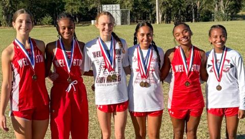 Wellington High School sophomore Taytum Kane claimed the district cross country championship, setting a new personal record of 12:07.49, at the District 2-2A Cross Country Championship Wednesday, Oct. 8 in Wheeler. From left: Anna Henard, Angela Lewis, Taytum Kane, Sabrina Segovia, Aleah Lewis, Kobee Lewis. Wellington High School