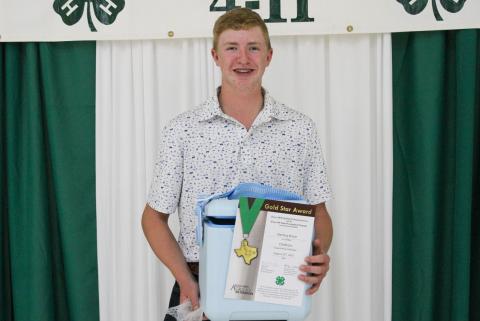 Sterling Bruce receives the Gold Star Award — the highest achievement award a Texas 4-H member can receive — at the 2025 Childress County 4-H Year End Banquet Monday, Aug. 25 at Fair Park City Auditorium. The Red River Sun/ElizabethTanner