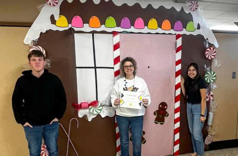 Memphis High School Family, Career and Community Leaders of America (FCCLA) Adviser Summer Lindley accepts first place in the holiday door decorating contest, thanks to her rendition of a gingerbread house. Photos Courtesy of Memphis ISD