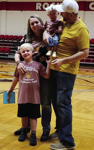 Natasha and Justin Mixon, with Landry and Kaydence, accept Wellington Junior High’s “Penny War” gift during the Nov. 3 Firecracker pep rally. A contest between the school’s students and staff, the sixth-grade class won the competition. The family posed for photos with several supporters following the presentation. Photo Courtesy of Marcela Rodriguez