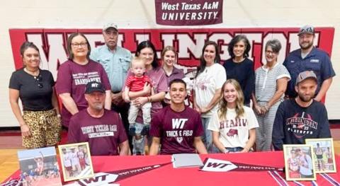 Surrounded by his family, Wellington High School senior Major Brown signs his National Letter of Intent to continue his track and field career at West Texas A&amp;M University Thursday, April 23. Front, from left: his dad, Daryon Brown, M. Brown, sister Marlee Brown Killian, brother Nathan Brown. Back row, from left: Lauren Patterson, Marie White, Pat White, Boone and Emily Cummings, Addisyn and Landree Wood, Leslee Wood, Lesa Thornberry, Cathy Needham, Matt Needham.