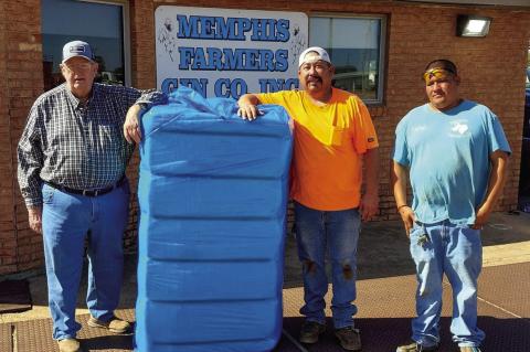 Memphis’ Jim Stewart, left, harvests the first bale of the 2024 cotton crop ginned at Memphis Farmers Gin Cooperative, Inc. Thursday, Oct. 24. Stewart, who also serves the First Baptist Church of Memphis Minister of Music, farms cotton in the surrounding area. A graduate of Memphis High School, he attended West Texas A&amp;M University, where he earned a Bachelor and Master of Arts in Music, which he used to teach music at Clarendon College prior to his retirement. Courtesy Photo