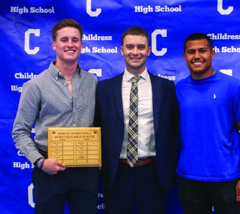 Head boys’ basketball coach Wayne Parker, center, awards Bobcat Basketball Offensive Most Valuable Player Aiden Allen, left, and Bobcat Basketball Defensive Most Valuable Player Isaiah Jalomo, right.
