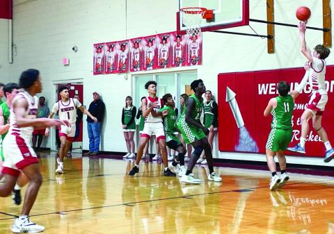 Skyrocket Carson Tarver (2) puts in two of his nine points on the board, while Bryant Tarver (11), Brenden Garcia (1) and Jordan Nation (4) come in for the rebound last Friday, Feb. 10 in Rocket territory. The Red River Sun/Shauna Salinas