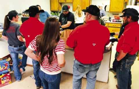 Wellington volunteer firemen, family members and Brothers-Sisters of our Military (B.O.O.M.) Adventures volunteers assemble brisket sandwich meal sacks for the Salinas family fundraiser Sunday, March 2. From left: Marcie Orr, Jonathan Hamby, Larry Valles, Brylnn Kemp, Joe Carrol, Molly Sims, Makenzie Smith, Whitney Wiebe, Chance Byers, Teresa Valles, Benny Wiebe, Henry Wiebe. The Red River Sun/Bev Odom